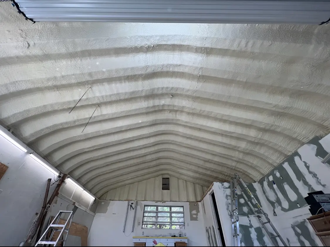 Spray polyurethane foam applied to the underside of a metal roof deck in Kendall West